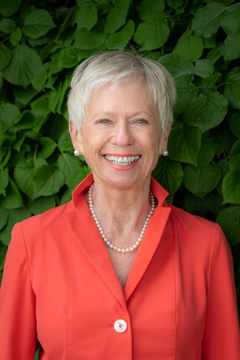 Linda Ann Daly is smiling in a headshot taken outside