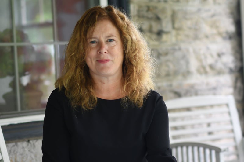 M. Eleanor McGrath sits outside of her farmhouse