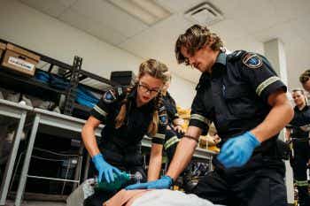 Two paramedic students in paramedic lab