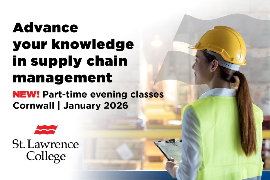 A woman wearing a hard hat holds a clipboard in a warehouse