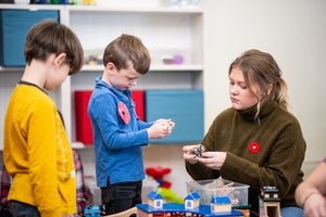 Student playing with children