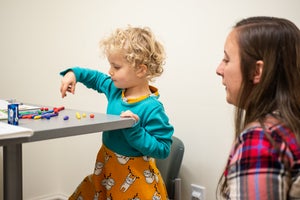 Student playing with a kid
