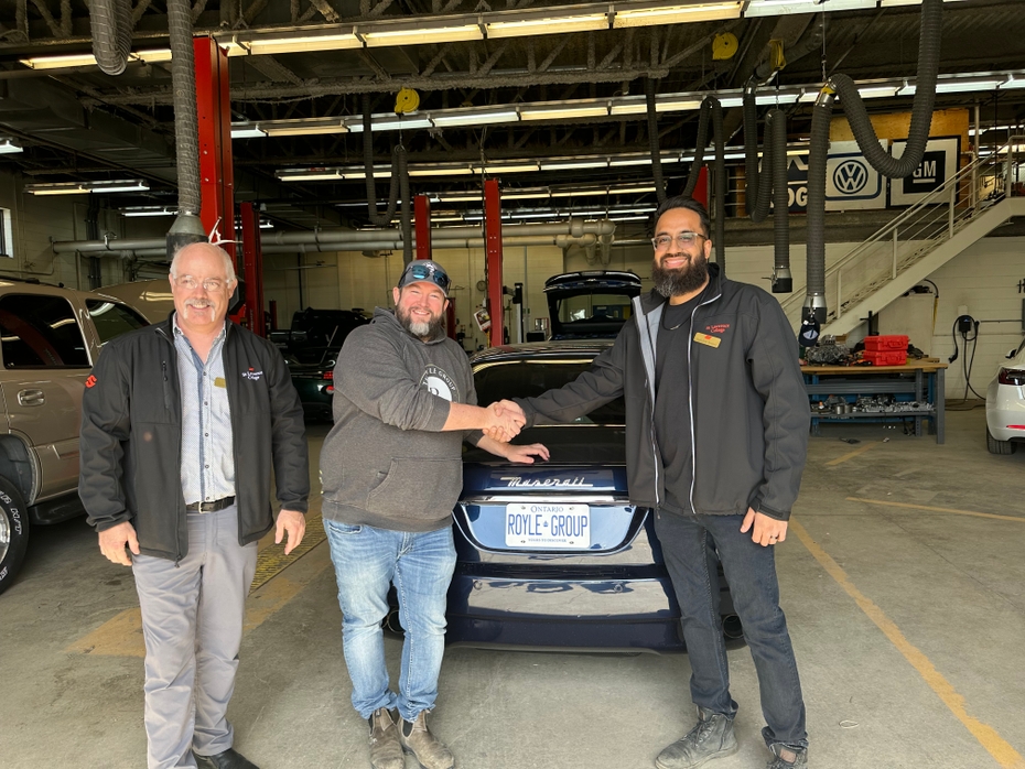 Travis Royle pictured with Aidan Wornes Associate Dean, School of Trades and Head of Apprenticeship for SLC, Saifullah Sanaye Professor of Automotive Technology and Automotive Program Coordinator,in front of the Maserati with licence plate Royle Group